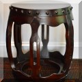 F53. One of a pair of carved wood Chinese drum tables. 